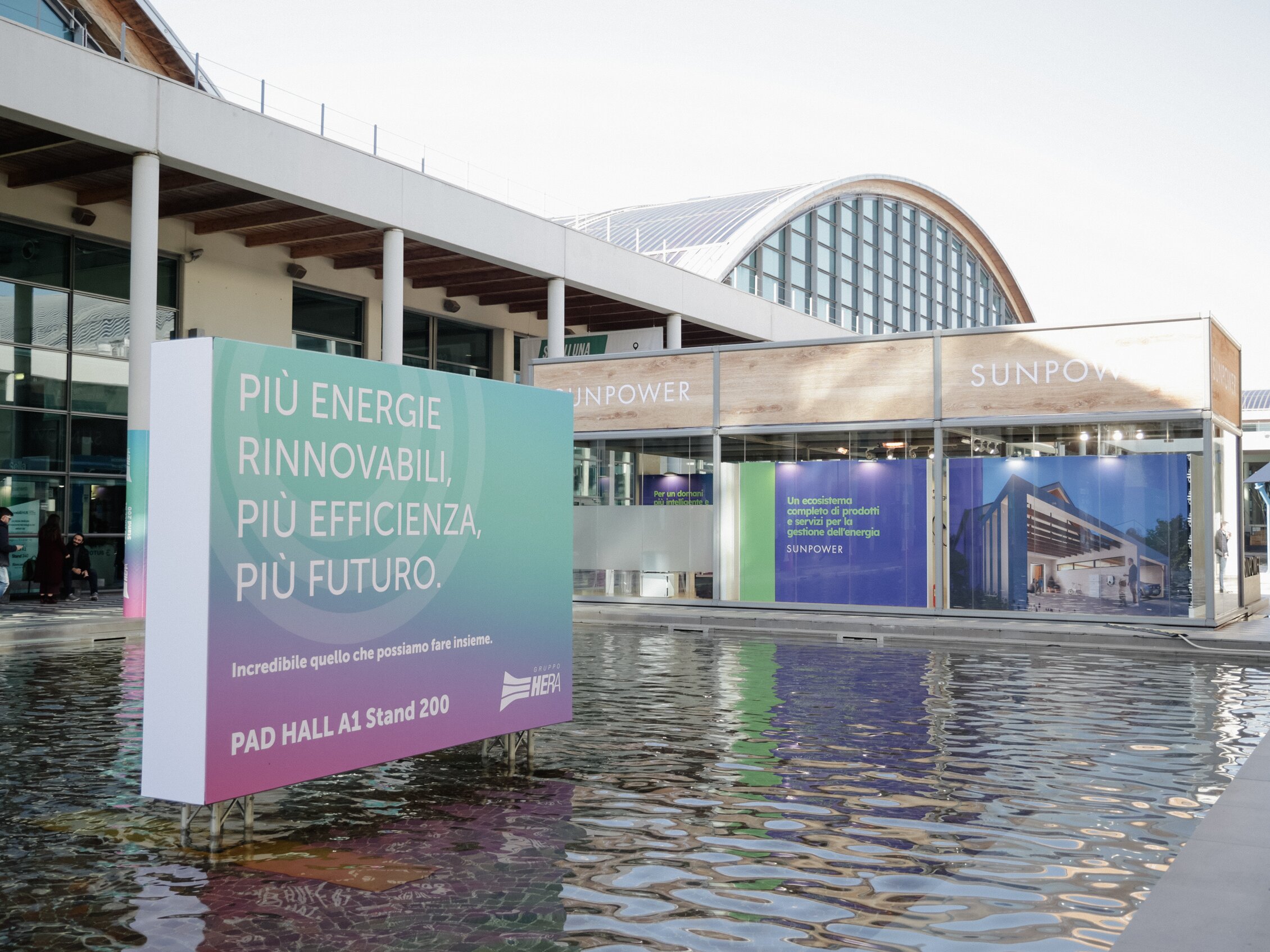 an installation  reading 'more renewable energy, more efficiency, more future' within a swimming pool inside the rimini expo centre 