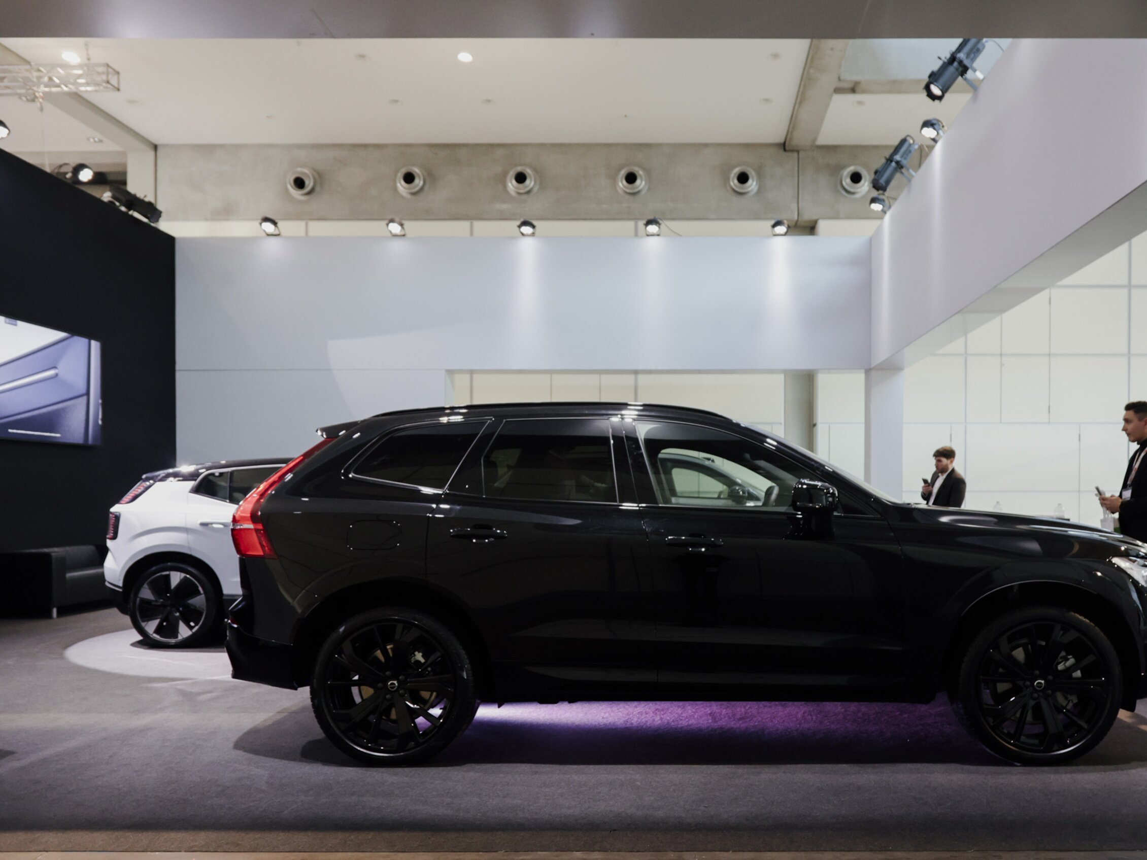 two cars parked inside an exhibition booth during KEY