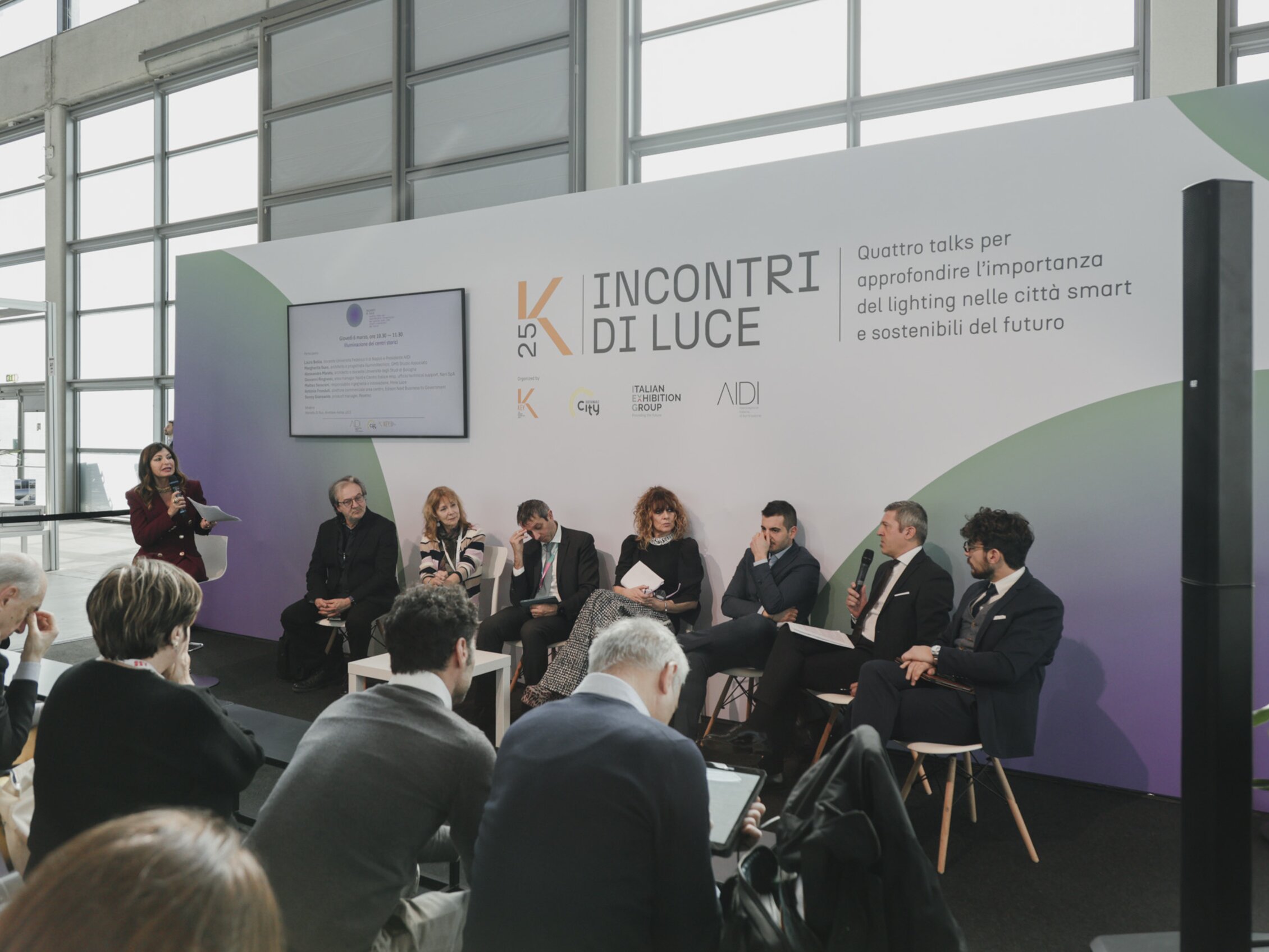  speakers on stage during a conference focusing on the importance of lighting in smart and sustainable cities of the future