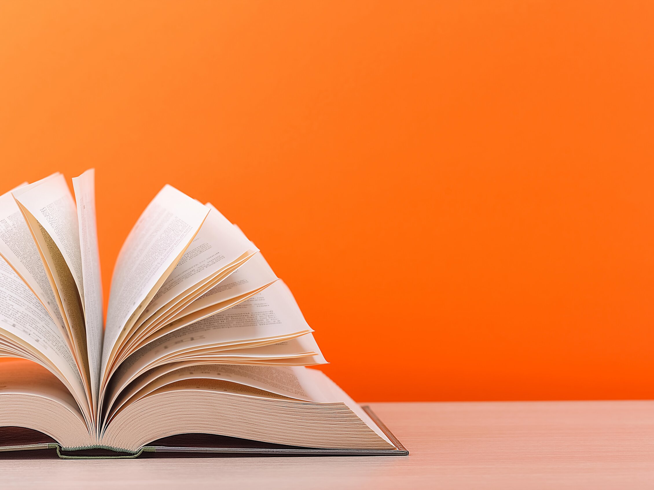 an open book with orange background 