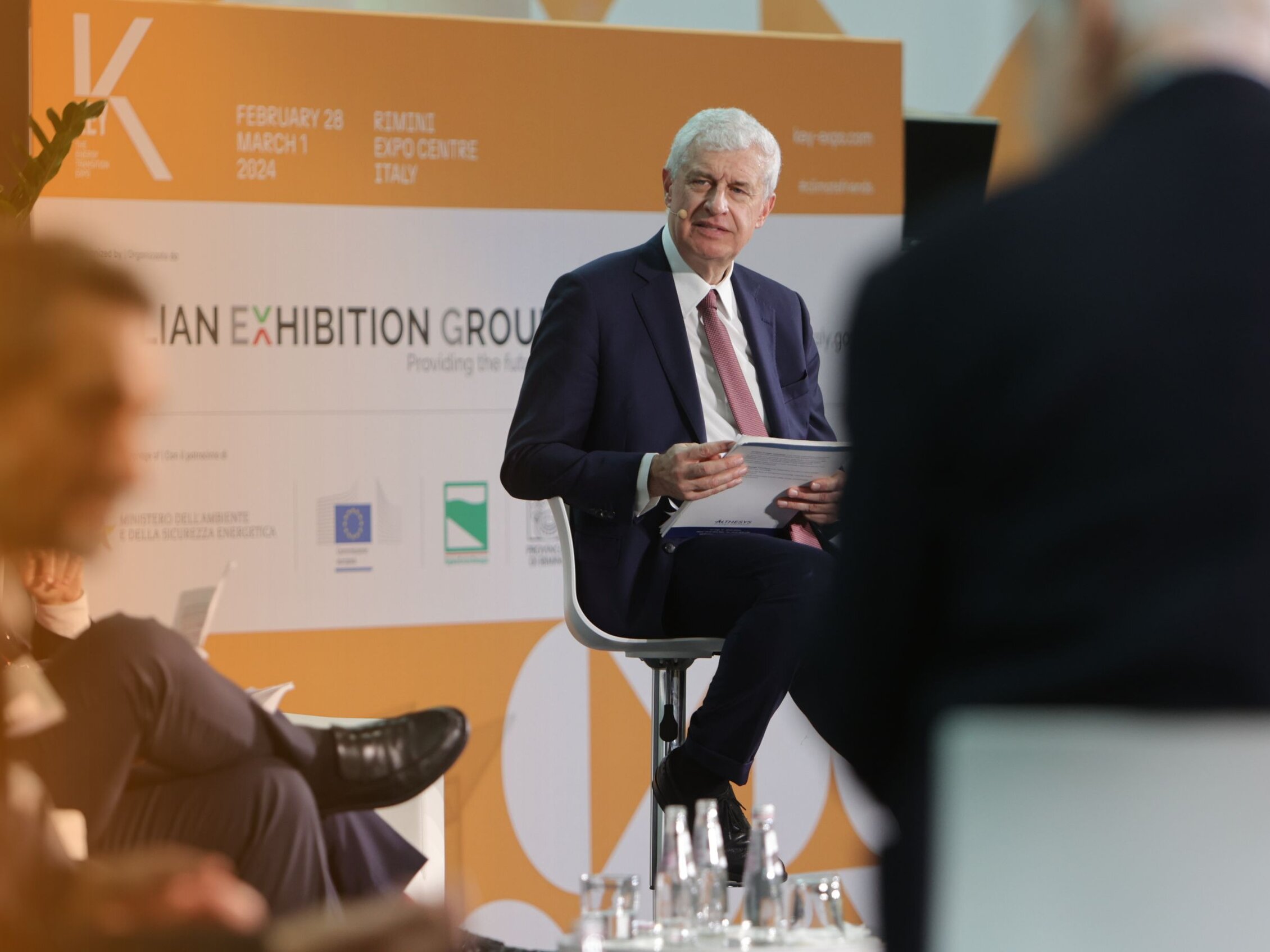 speaker sitting on stage during a KEY conference